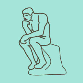 Man sitting on a rock with his fist on his chin.